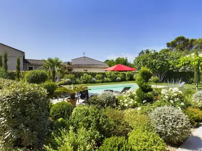 a garden with a car parked in a yard at Villa rénovée à Eygalières avec piscine chauffée - FR-1-599-19 in Eygalières