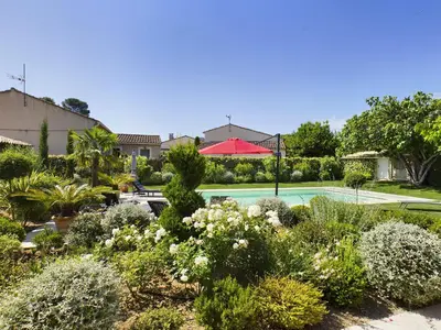 a garden with a swimming pool and plants at Villa rénovée à Eygalières avec piscine chauffée - FR-1-599-19 in Eygalières