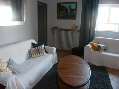 a living room with a white couch and a table at bastide St Joseph in Eyguières
