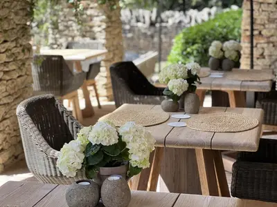 a wooden table with vases with white flowers on it at Le Mas de Béthel in Gordes