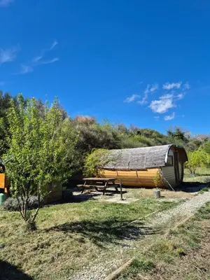 a wooden boat sitting next to a picnic table at Hébergements insolites - Détente en Luberon in Viens