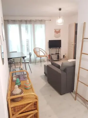 a living room with a couch and a table at vintage home in LʼIsle-sur-la-Sorgue