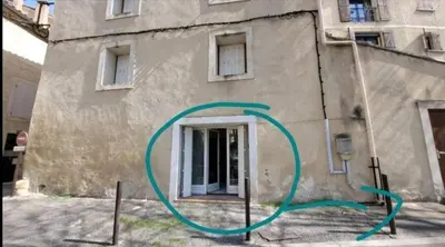a building with a green circle on the side of it at vintage home in LʼIsle-sur-la-Sorgue