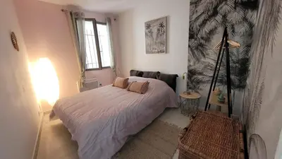 a bedroom with a bed and a lamp in it at vintage home in LʼIsle-sur-la-Sorgue