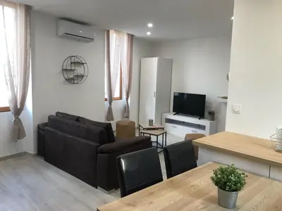 a living room with a couch and a table at Gite au cœur du ventoux in Bédoin