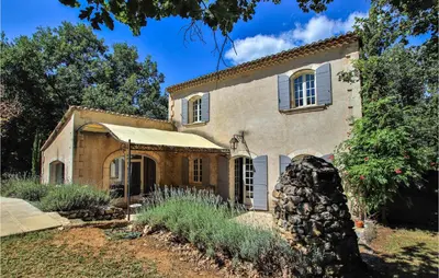 an old stone house in the middle of a yard at Pet Friendly Home In Apt in Apt