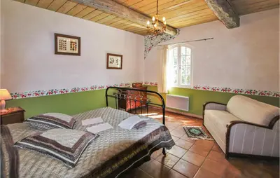 a bedroom with a bed and a couch in a room at Pet Friendly Home In Apt in Apt