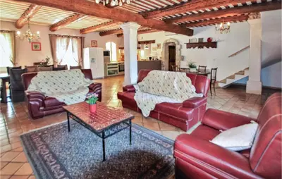 a living room with red couches and a table at Pet Friendly Home In Apt in Apt