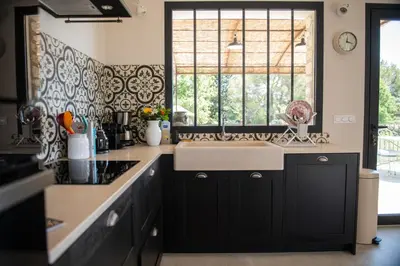 a kitchen with a sink and a window at Bastide Toujours Dimanche, Maison de vacances avec vue & piscine chauffée in Gordes
