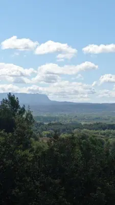 a view of a valley with mountains and trees at Les Cigales in Villelaure