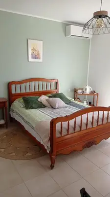 a bedroom with a wooden bed in a room at Les Cigales in Villelaure