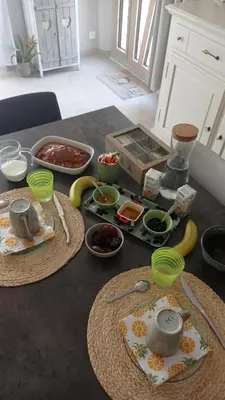 a table with plates of food and bowls of food at Les Cigales in Villelaure