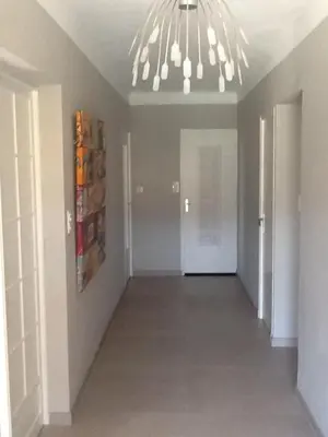 an empty hallway with a chandelier in a house at Le temps des cerises in Méthamis