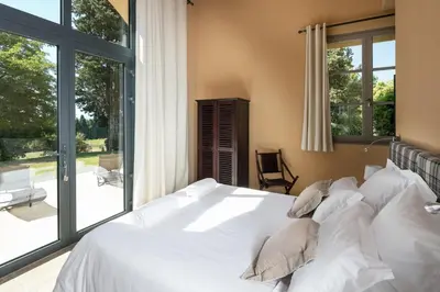 a bedroom with a bed with white sheets and pillows at Château des Cinq Cantons in Carpentras