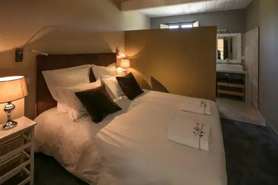 a bedroom with a large white bed with pillows at Château des Cinq Cantons in Carpentras