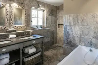 a bathroom with a tub and a sink at Château des Cinq Cantons in Carpentras