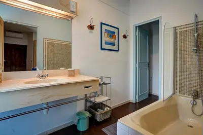a bathroom with a sink and a bath tub at La Chaumière, Demeure d'hôtes in Lauris