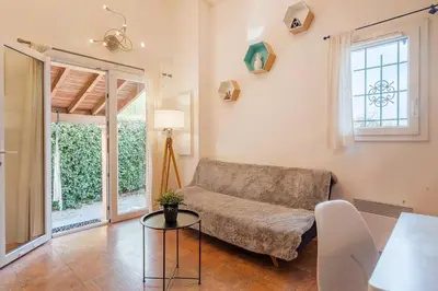 a living room with a couch and a table at Le Jardin des Alpilles in Eyguières