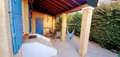 a porch with a hammock and a swing at Le Jardin des Alpilles in Eyguières