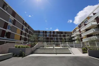 a large apartment building with stairs in front of it at Beau studio Monteux, balcon vue Lac, près de Spirou Provence in Monteux