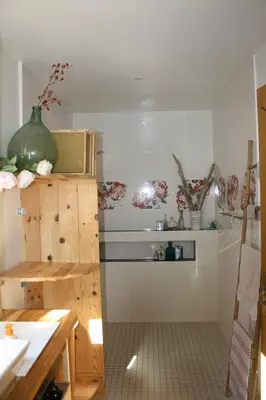 a kitchen with a sink and a microwave at À l'ombre du mûrier in Blauvac