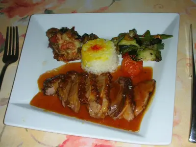 a plate of food with meat and vegetables on a table at Hostellerie Le Mirabeau in Peyrolles-en-Provence