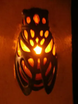 a candle holder with a light on the floor at Hostellerie Le Mirabeau in Peyrolles-en-Provence