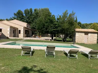 a group of chairs sitting next to a swimming pool at Mas Galinette in Saint-Andiol