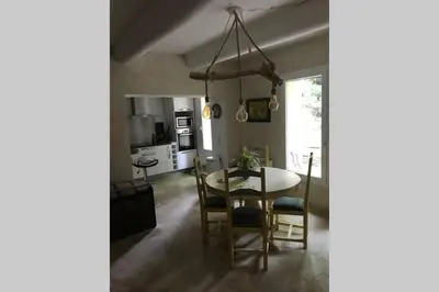 a kitchen and dining room with a table and chairs at Le jardin in Aix-en-Provence