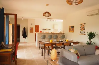 a living room with a couch and a table at Maison Le Grand Verger in Goult