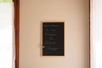 a chalkboard on a wall next to a door at Maison Le Grand Verger in Goult
