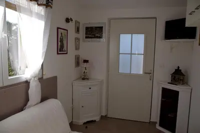a bedroom with a bed and a door and a window at Chez Mamou & Dadou in Monteux