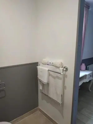 a bathroom with towels hanging on a wall at La ferme des Escampades in Monteux