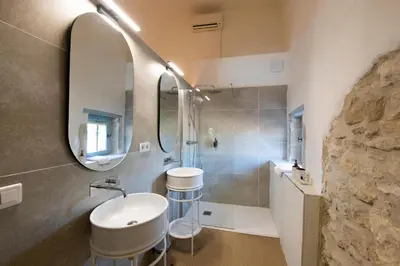 a bathroom with a sink and a mirror at Au Ralenti du Lierre in Beaumettes