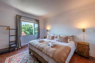 a bedroom with a large bed with two pillows on it at Au Ralenti du Lierre in Beaumettes