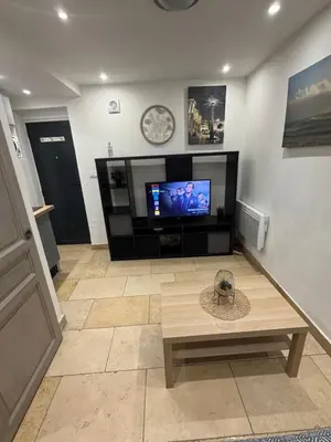 a living room with a tv and a coffee table at Studio plein centre aix en Provence in Aix-en-Provence