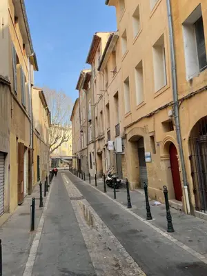 an empty street with a row of poles on the side at Studio plein centre aix en Provence in Aix-en-Provence