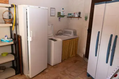 a small kitchen with a sink and a refrigerator at VILLA PROVENCALE FACE AU LUBERON in Cabrières-dʼAvignon