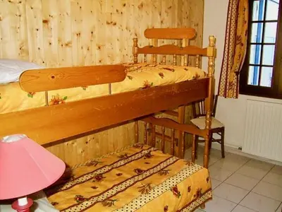 a bedroom with two bunk beds and a pink lamp at le vieux pont in Carpentras