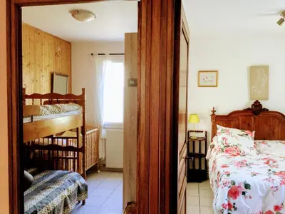 a bedroom with a bed and a crib in it at le vieux pont in Carpentras