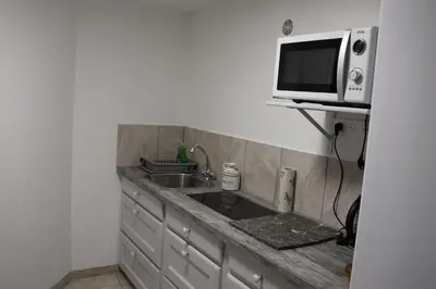 a kitchen with a sink and a microwave at Les BRUNS in Saignon