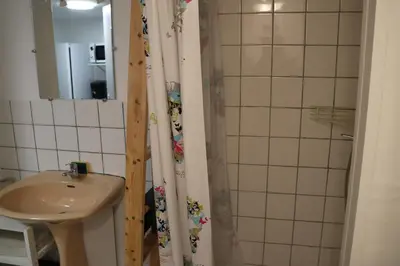 a bathroom with a sink and a shower curtain at Les BRUNS in Saignon