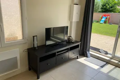 a flat screen tv sitting on top of a black entertainment center at Loft 21 m² pouvant accueillir 4 personnes in Monteux