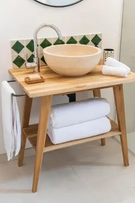 a sink on a wooden table with towels at La Petite Ruche, 1 bedroom Gite in the Luberon in Apt