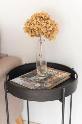 a glass vase with a flower on a table at La Petite Ruche, 1 bedroom Gite in the Luberon in Apt