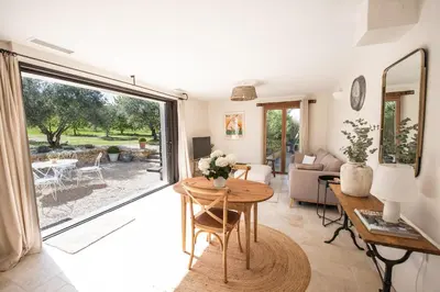 a living room with a table and a large window at La Petite Ruche, 1 bedroom Gite in the Luberon in Apt