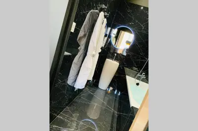 a bathroom with a sink and a mirror at Suite Le CEZANNE in Aix-en-Provence
