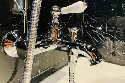 a bathroom sink with a glass bottle on it at Suite Le CEZANNE in Aix-en-Provence
