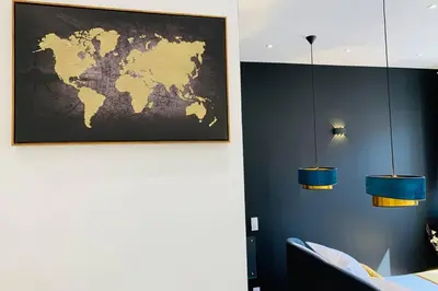 a room with two lights and a map on the wall at Suite Le CEZANNE in Aix-en-Provence