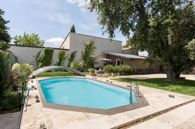 a swimming pool in the backyard of a house at Le Parc in Carpentras